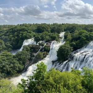Breathtaking view of cascading waterfalls amidst dense greenery in Chamarajnagar, India.