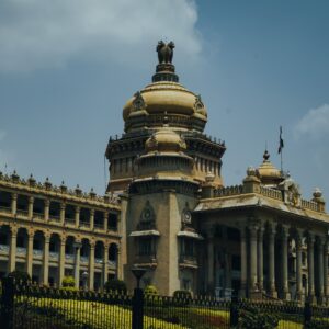 The majestic Vidhana Soudha in Bengaluru captured under a vibrant blue sky.